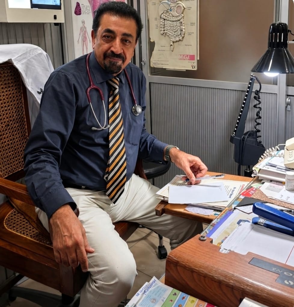Dr. Ayaz Saeed at clinic desk